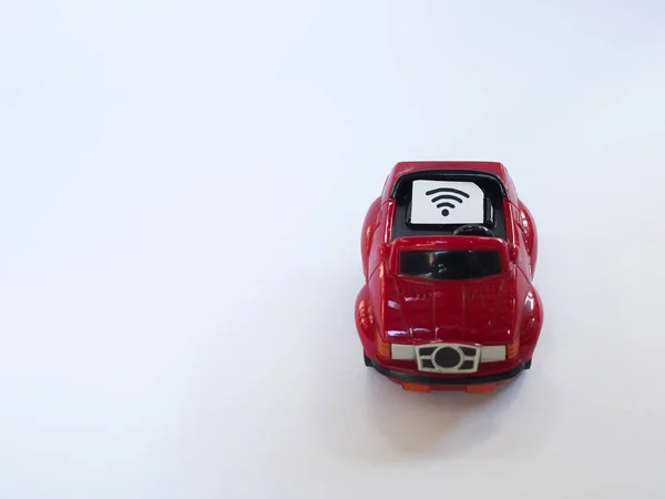 Sim card tray and small paper simulated as a SIM card on a red toy car with white background.  Wifi symbol on paper sim card — Stock Photo, Image