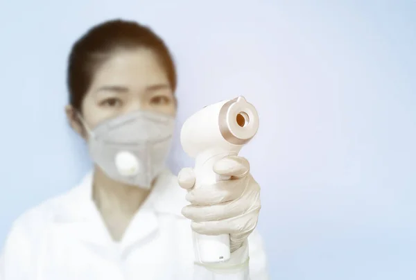 Woman Doctor Wearing Mask Holding Medical Infrared Forehead Thermometer Check — Stock Photo, Image