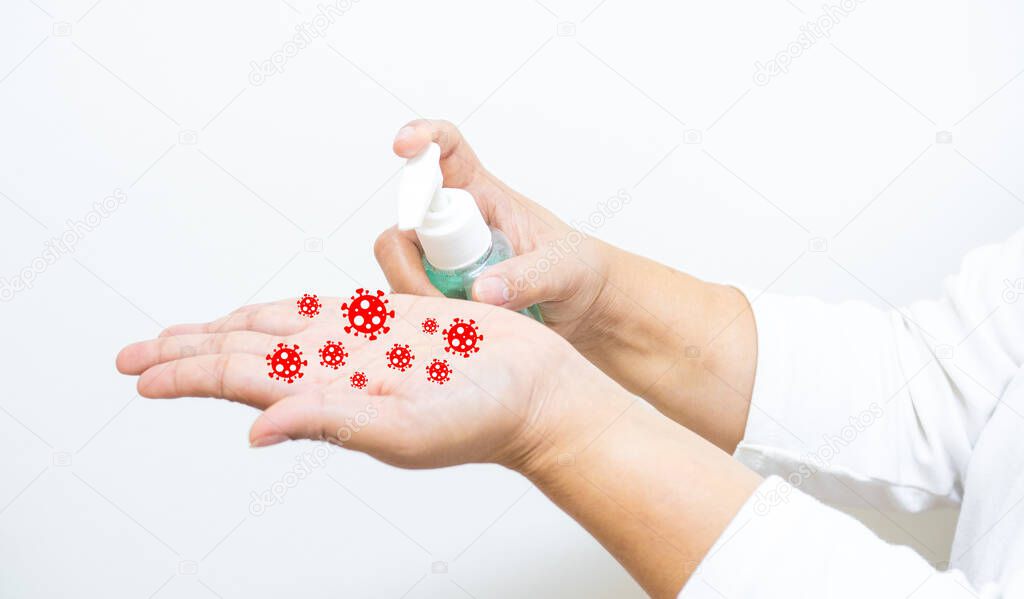 The woman's hand pressing alcohol gel from pump bottle to clean hands and prevent coronavirus infection, initial self-care during an epidemic crisis. Self-protection and healthcare concept.