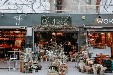 LONDON, UNITED KINGDOM - MARCH 9. 2016: Store front of Chez Michele flower shop in Borough Market, one of the largest and oldest food markets in London. clipart