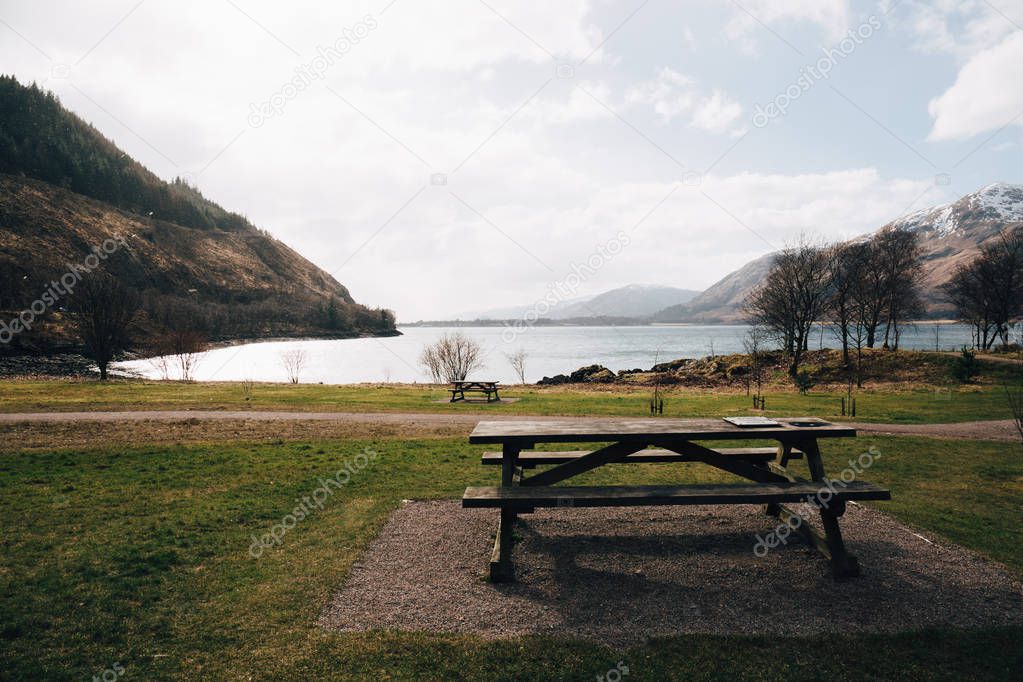Empty picnic table by Loch Eil, Fort William, Scotland, on a clear spring day. 