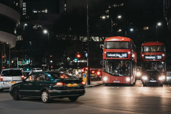 Красные двухэтажные автобусы и автомобили на одной из улиц Лондона, Великобритания, в т — стоковое фото