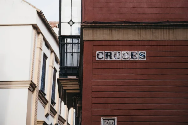 Street name sign on Cruces street in Seville, Andalusia, Spain.