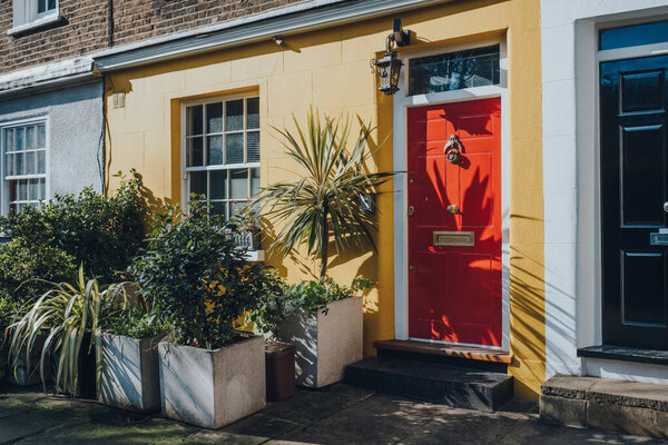 Colourful Bright Red Front Door Yellow House London Stock Image
