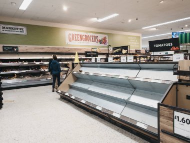 London, UK - March 19, 2020: Empty shelves in fruit and vegetables aisle of Morrisons supermarket in Palmers Green, London, as people stock up due to Coronavirus threat. clipart