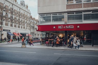 London, UK - March 06, 2020: People walk past Pret A Manger, a popular international sandwich shop chain that is based in UK and has approximately 500 shops in nine countries, in Central London. clipart