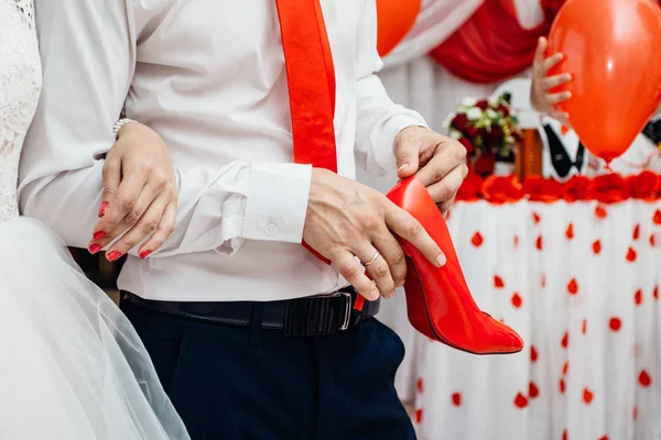 Un zapato de pepino cursi en las manos del novio — Foto de Stock