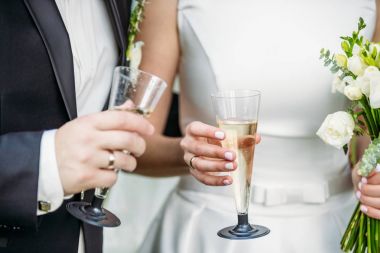 Ellerinde şampanya ile yeni evliler