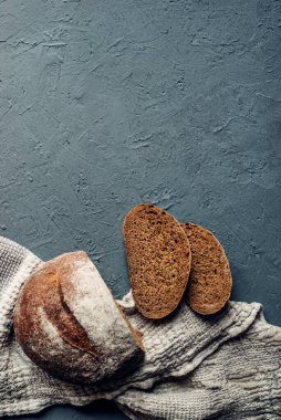 Fırından siyah ekmek, ev yapımı. Beton bir arka planda dilimlenmiş siyah ekmek, bir masanın üzerinde. düz yatış, üst görünüm