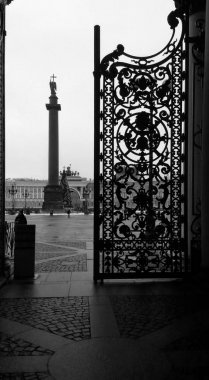View of the Palace Square and the Alexandrian Column with an Angel through an open cast-iron gate, St. Petersburg, Russia. Black and white photography. clipart