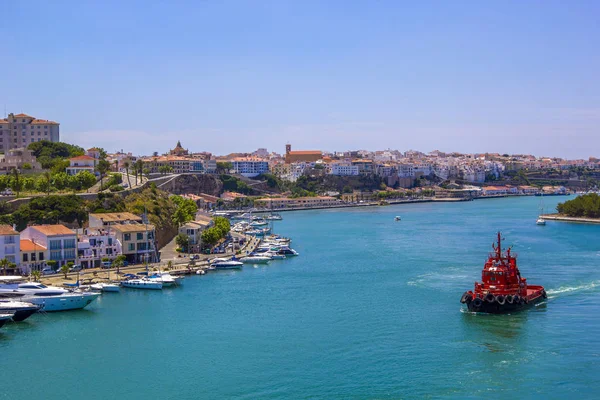 Red ship goes to harbour marina in Menorca on the coast of Spain