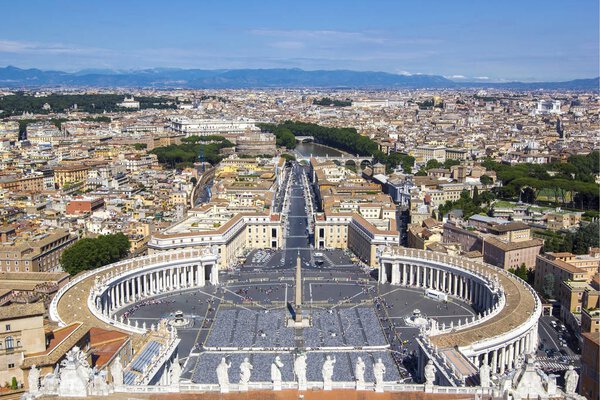 Panoramic view from the air to Saint Peter's Square, Vatican City and Rome, the Tevere (Tibr) River and mountains on the horizon on a summer sunny day, Italy