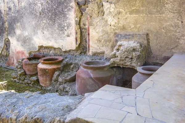 Ancient kitchen utensils - pots, vases from the excavations/ruins of the old city of Pompeii, Naples, Italy