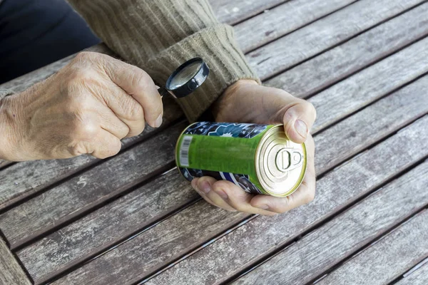 Elderly Man Reads Composition Food Product Magnifier Fine Print Can — Stock Photo, Image