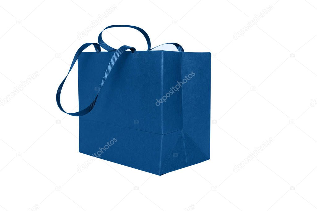 Gift paper bag, shopping bag in classic blue color isolated on white background. Mocr up of blank craft package. Concept for presents holidays, father's day