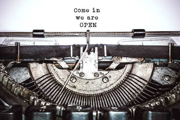 Old vintage typewriter, retro machine with white sheet of paper and typed text 