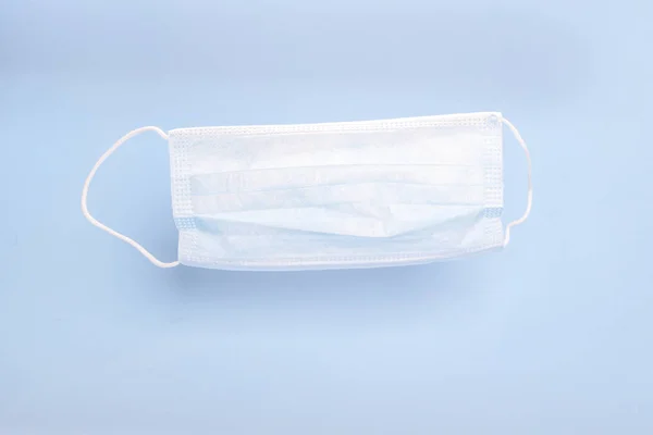Mavi Arka Planda Lastik Kulaklıklı Tıbbi Maske Bakterilerden Korunma Kavramı — Stok fotoğraf