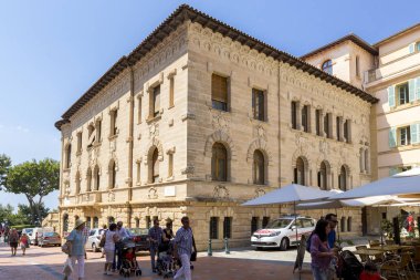 MONTE CARLO, MONACO - JUNE 10, 2014: Tourists walk along beautiful streets, promenade, sightseeing walk of Monte-Carlo in principality of Monaco, southern France