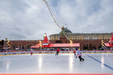 MOSCOW, RUSSIA - FEBRUARY 29, 2020: Happy people play hockey at rink on Red Square in Moscow, Russia