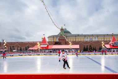 MOSCOW, RUSSIA - FEBRUARY 29, 2020: Happy people play hockey at rink on Red Square in Moscow, Russia