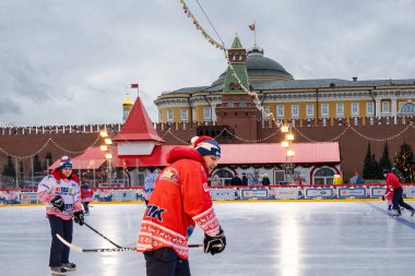MOSCOW, RUSSIA - FEBRUARY 29, 2020: Happy people play hockey at rink on Red Square in Moscow, Russia
