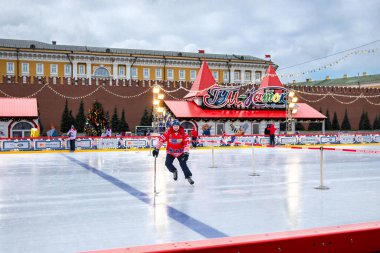 MOSCOW, RUSSIA - FEBRUARY 29, 2020: Happy people play hockey at rink on Red Square in Moscow, Russia