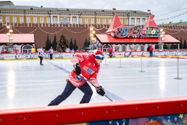 MOSCOW, RUSSIA - FEBRUARY 29, 2020: Happy people play hockey at rink on Red Square in Moscow, Russia