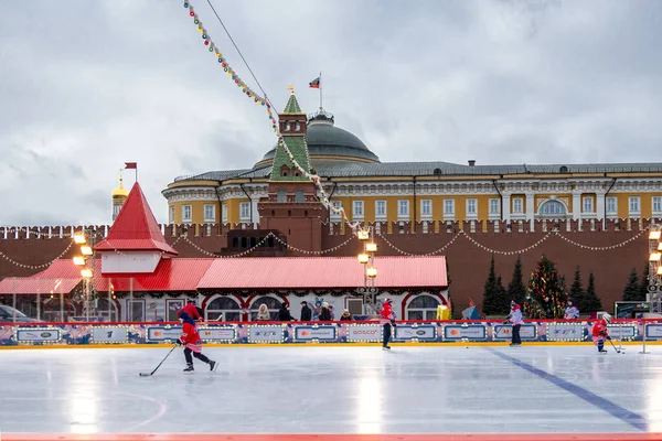 MOSCOW, RUSSIA - FEBRUARY 29, 2020: Happy people play hockey at rink on Red Square in Moscow, Russia