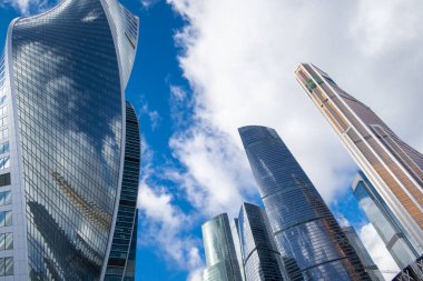 MOSCOW, RUSSIA - FEBRUARY 29, 2020: Skyscrapers modern architecture office building with clouds in blue sky, high tech style of Moscow City, looking up, Moscow, Russia