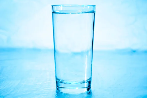 Glass of water in blue