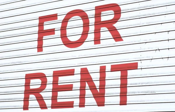 FOR RENT - text printed on a metal surface in red.
