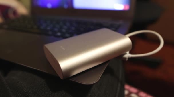 Future is now. Young girl using portable battery charger for mobile phone. Easy way to have cellphone working any time. Laptop charging from a USB power bank. The indicator flashes. — Stock Video