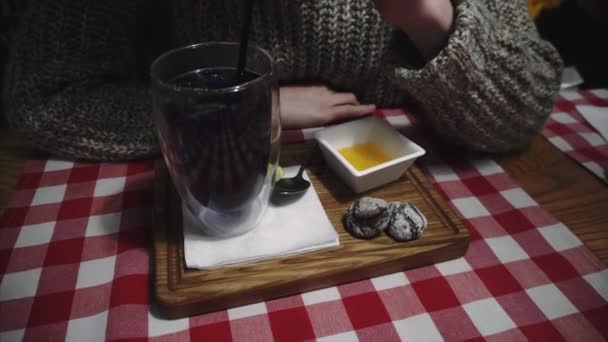 Gurmánská dívka ochutnává modrý čaj Anchan, pije horký nápoj přes sidch v kavárně večer po studiu nebo práci. — Stock video