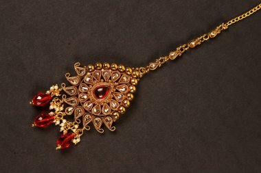 Orijinal Geleneksel Hint Mücevherleri Tika Karanlık Arkaplanda. Düğünde, festivallerde ve diğer etkinliklerde kafanızı takın. Web Sitesi, Yazdırma ve Mobil Uygulama için çok kullanışlı bir resim.