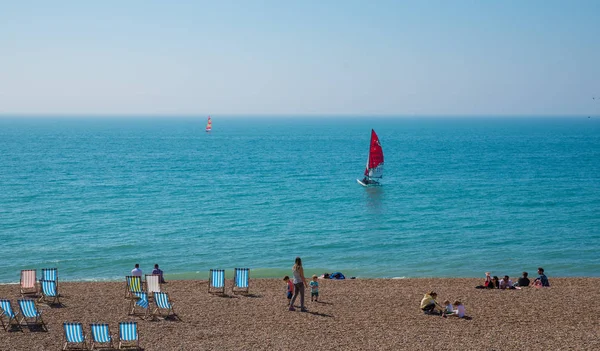 Dubna, 9. 2017, Brighton, Velká Británie. Lidé si za slunečného dne na Brighton beach — Stock fotografie