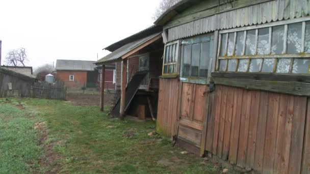 Vieille maison en bois abandonnée et ruinée. Fenêtres et mur avec vieux toit endommagé avec peinture altérée. Gros plan. 4k . — Video