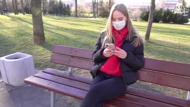 Young Woman Red Protective Mask Using Smartphone Calling Recording Video — Stock Video