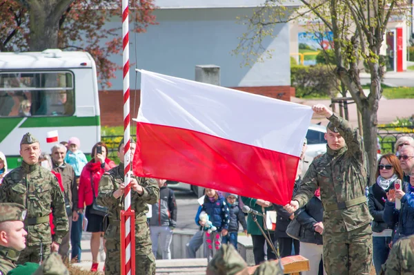 Pruszcz Gdanski, Polska - 3 maja 2017: Polski żołnierz wisi flaga Polski podczas uroczystości 3 maja Konstytucji. — Zdjęcie stockowe