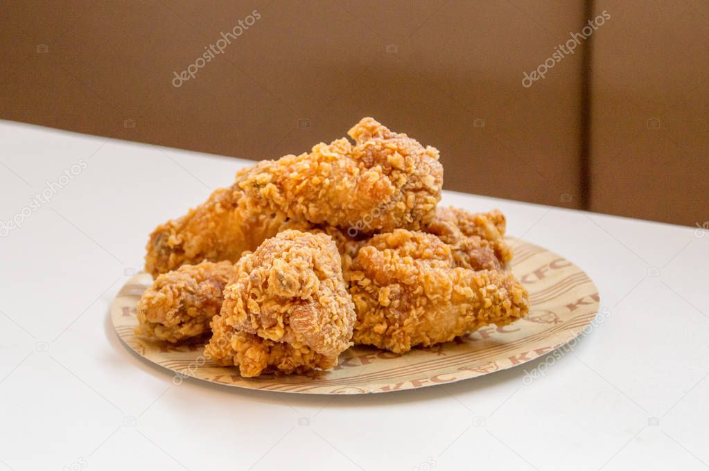 Gdansk, Poland - February 28, 2018: Fried chicken hot wings from KFC (Kentucky Fried Chicken) fast food.