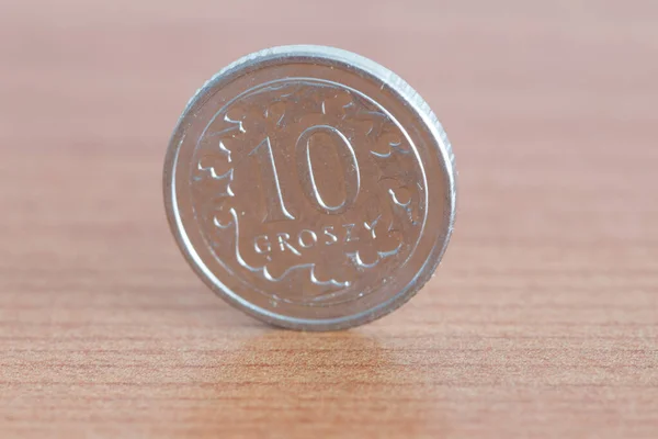 Polish 10 groszy coin on wooden table. — Stock Photo, Image