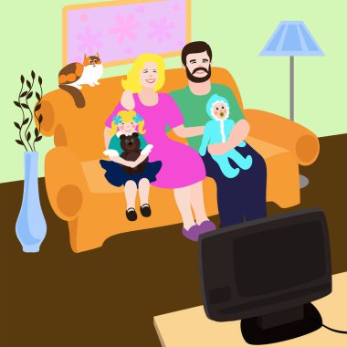 İki çocuklu mutlu bir aile evde kedileriyle kanepede oturur ve televizyon seyreder..