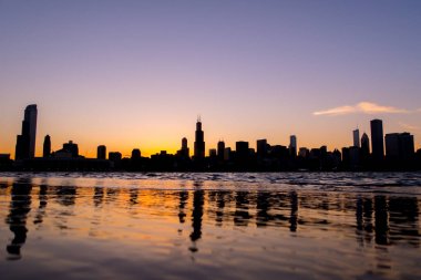 Chicago manzarası resim güzel turuncu sarı güneş bu kadar sırasında bina siluetleri ve ön planda Michigan Gölü su yansımaları aşağıdaki düşürür