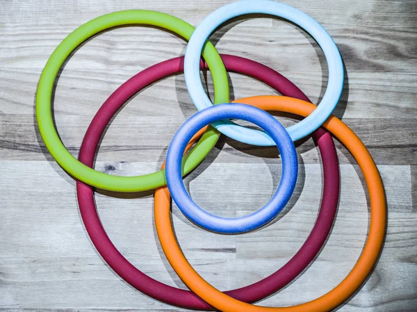 Beautiful abstract photograph of colorful circular ring shaped flexible silicone pot holders of various sizes and rainbow colors making a great background, backdrop or wallpaper image.