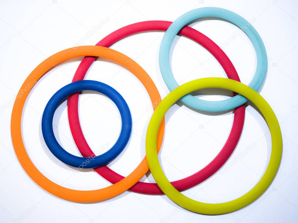 Beautiful abstract photograph of colorful circular ring shaped flexible silicone pot holders of various sizes and rainbow colors making a great background, backdrop or wallpaper image.