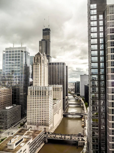 Vue du centre-ville de Chicago depuis un gratte-ciel en direction de Willis Tower anciennement Sears Tower avec la rivière Chicago vert foncé et des ponts en dessous et ciel nuageux au-dessus . — Photo