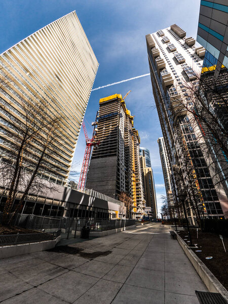 Chicago, IL - March 21st, 2018: Construction crews work on Vista Tower by Jeanne Gang and foundations at the adjacent GEMS World Academy by bKL along Wacker drive and the river in downtown.