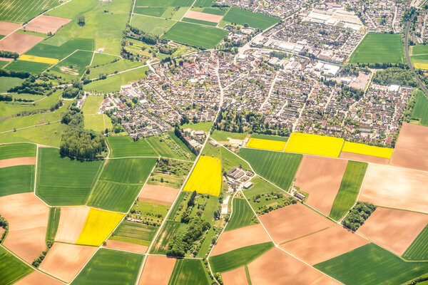 Аэрофотосъёмка лоскутного полотна с зелеными и желтыми фермерскими полями и домами возле Франкфурта Германия, сделанная с самолета, который делает большой перелет или сельскохозяйственный фон
.