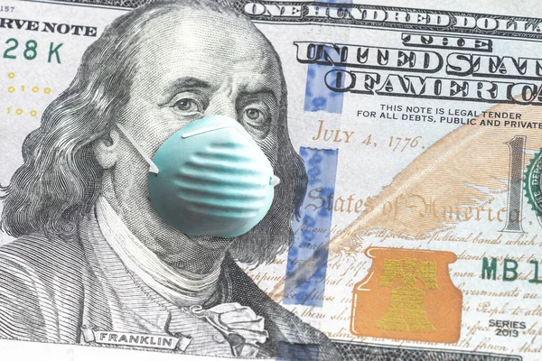 ABD kağıt para birimini kapatın. 100 dolarlık banknot. Benjamin Franklin, COVID-19 salgınından dolayı mavi maske takıyor..