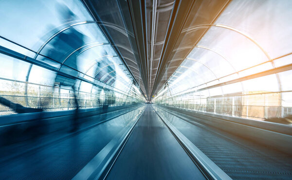Abstract Blurred business commuters rushing on a skywalk in a modern airport. ideal for websites and magazines layouts