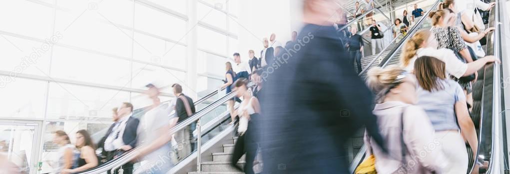 crowds of people in motion blur on a trade fair